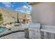 This outdoor kitchen features stainless steel appliances, stone accents, and an outdoor patio with a pool at 2124 Pont National Dr, Henderson, NV 89044