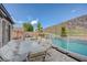 Inviting pool area with comfortable seating, creating a tranquil oasis for outdoor relaxation and entertainment at 2124 Pont National Dr, Henderson, NV 89044