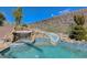 A luxurious backyard pool area, featuring a waterfall, spa, and slide for entertainment and relaxation at 2124 Pont National Dr, Henderson, NV 89044