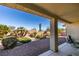 Lush backyard featuring desert landscaping and a covered patio at 2192 Tiger Links Dr, Henderson, NV 89012