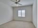 Bright bedroom with a ceiling fan and a window with shutter-style blinds at 2192 Tiger Links Dr, Henderson, NV 89012