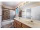 Bathroom featuring a dual sink vanity, tub, shower, and large mirror with Hollywood-style lighting at 2244 Brighton Shore St, Las Vegas, NV 89128