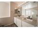 Bright bathroom features a double vanity with quartz countertop, framed mirrors and ample lighting at 2244 Brighton Shore St, Las Vegas, NV 89128