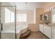 Bathroom featuring a soaking tub, separate shower, and a vanity with double sinks and bright vanity lighting at 2244 Brighton Shore St, Las Vegas, NV 89128