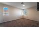 Neutral bedroom featuring soft carpet, windows and a mounted television at 2244 Brighton Shore St, Las Vegas, NV 89128