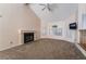 Carpeted living room with vaulted ceilings, a fireplace, and large windows at 2244 Brighton Shore St, Las Vegas, NV 89128