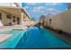 Long rectangular pool featuring a stone waterfall wall with desert landscaping at 2244 Brighton Shore St, Las Vegas, NV 89128