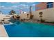 Long rectangular pool featuring a stone waterfall wall with desert landscaping at 2244 Brighton Shore St, Las Vegas, NV 89128