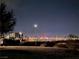 Nighttime view of the Las Vegas city skyline from a community park with desert landscaping at 2498 Veronella St, Henderson, NV 89044