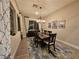 Formal dining room with chandelier, wood table, rug, and view to the exterior at 2498 Veronella St, Henderson, NV 89044