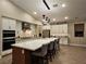 Open concept kitchen with large island, modern lighting, stainless steel appliances, and white cabinetry at 2498 Veronella St, Henderson, NV 89044