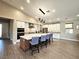 Open concept kitchen with large island, modern lighting, stainless steel appliances, and white cabinetry at 2498 Veronella St, Henderson, NV 89044