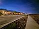 Street view of modern homes with manicured landscaping during a beautiful dusk sky at 2498 Veronella St, Henderson, NV 89044