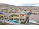 Expansive aerial view of a solar-paneled home featuring a private backyard with a pool and putting green at 2593 Indigo Cloud Ct, Las Vegas, NV 89142