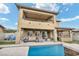 Two-story home showcasing a stunning pool, built-in outdoor kitchen and covered patio at 2593 Indigo Cloud Ct, Las Vegas, NV 89142