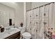 Well-lit bathroom featuring a modern vanity and a decorative shower curtain at 2593 Indigo Cloud Ct, Las Vegas, NV 89142