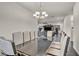 A modern dining room with a stylish table set for ten, bathed in natural light at 2593 Indigo Cloud Ct, Las Vegas, NV 89142