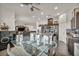 Open concept kitchen with a granite island, stainless steel appliances, dark cabinets, and an adjacent dining area at 2593 Indigo Cloud Ct, Las Vegas, NV 89142