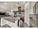 Spacious kitchen with granite counters, a large center island, stainless steel appliances, and dark wood cabinets at 2593 Indigo Cloud Ct, Las Vegas, NV 89142