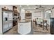 A modern kitchen featuring stainless steel appliances, dark wood cabinetry, and a granite countertop island with sink at 2593 Indigo Cloud Ct, Las Vegas, NV 89142