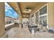 Gourmet outdoor kitchen under a covered patio, featuring stainless steel appliances and granite countertops at 2593 Indigo Cloud Ct, Las Vegas, NV 89142