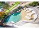 Overhead view of a private pool with a sandy beach entry and desert landscaping at 2793 Red Arrow Dr, Las Vegas, NV 89135