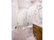 Modern bathroom featuring a glass shower, pebble flooring, and stylish wood vanity with a marble countertop at 2793 Red Arrow Dr, Las Vegas, NV 89135