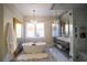 Bright bathroom featuring a soaking tub, a glass-enclosed shower and stylish lighting at 2793 Red Arrow Dr, Las Vegas, NV 89135