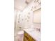 A contemporary bathroom with glass shower, white textured walls with starburst decor, and marble countertop at 2793 Red Arrow Dr, Las Vegas, NV 89135