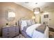 An elegant bedroom featuring a stylish chandelier, textured wallpaper, and luxurious furnishings at 2793 Red Arrow Dr, Las Vegas, NV 89135