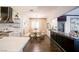 Bright dining area with a booth, table with seating, a chandelier, and views into the kitchen at 2793 Red Arrow Dr, Las Vegas, NV 89135