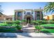 A beautiful luxury home with a meticulously landscaped front yard and stone facade at 2793 Red Arrow Dr, Las Vegas, NV 89135