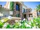 Charming stone facade featuring lush flowerbeds, a private balcony, and lantern-style lighting at 2793 Red Arrow Dr, Las Vegas, NV 89135