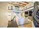 Grand living room with beamed ceilings, stone fireplace, and wrought iron staircase at 2793 Red Arrow Dr, Las Vegas, NV 89135