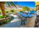 Built-in stainless steel grill and a bar with seating offer a fun space for entertaining in this outdoor kitchen at 2793 Red Arrow Dr, Las Vegas, NV 89135