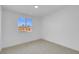 Bright bedroom features a window that offers a glimpse of the neighborhood and blue sky at 2801 Emmons Ave, North Las Vegas, NV 89030