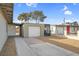 Long driveway with an attached garage and a covered structure and gravel landscaping at 2801 Emmons Ave, North Las Vegas, NV 89030