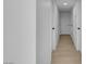 Clean and freshly painted hallway with recessed lighting and wood-look flooring at 2801 Emmons Ave, North Las Vegas, NV 89030