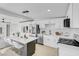 Modern kitchen featuring stainless steel appliances, a central island with seating, and sleek white cabinetry at 2801 Emmons Ave, North Las Vegas, NV 89030