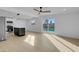 Bright living room with a ceiling fan, a sliding glass door to the pool and views into the kitchen at 2801 Emmons Ave, North Las Vegas, NV 89030