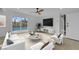 Bright living room with a view of the pool, contemporary furnishings, and a ceiling fan at 2801 Emmons Ave, North Las Vegas, NV 89030