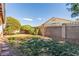 Backyard featuring lush green bushes, stone landscaping, and a concrete perimeter wall at 286 Fairmeadow St, Henderson, NV 89012