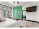 Bedroom featuring sliding glass doors, tv, ensuite access, and bold, patterned wallpaper at 286 Fairmeadow St, Henderson, NV 89012