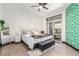 Bright bedroom featuring patterned wallpaper, ceiling fan, and sliding glass doors to the backyard at 286 Fairmeadow St, Henderson, NV 89012