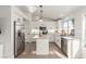 Modern kitchen with white cabinets, granite island, and stainless steel appliances at 286 Fairmeadow St, Henderson, NV 89012