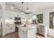 Modern kitchen with white cabinets, granite island and stainless steel appliances at 286 Fairmeadow St, Henderson, NV 89012