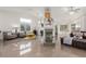 Open-concept living area with tile flooring, fireplace, and views to the kitchen at 286 Fairmeadow St, Henderson, NV 89012
