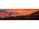 Neighborhood sunset view showcasing mountains, palm trees and a fiery sky at 286 Fairmeadow St, Henderson, NV 89012