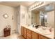 Well-lit bathroom featuring double sinks, neutral walls, tile flooring, and a walk-in shower at 3353 Kylemore St # 101, Las Vegas, NV 89129