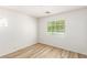 Well-lit bedroom featuring wood-look floors and a large window at 3357 Sheep Canyon St, Las Vegas, NV 89122